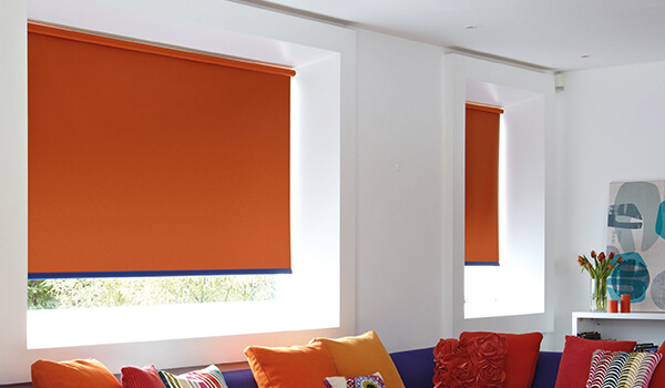 Orange Blackout Roller Blinds in living room