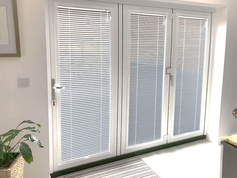 White venetian bi-fold door blinds