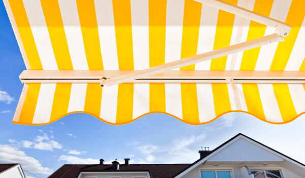 yellow and white striped canopy traditional shop awnings