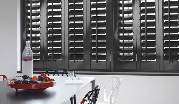 Grey wooden shutters in dining room