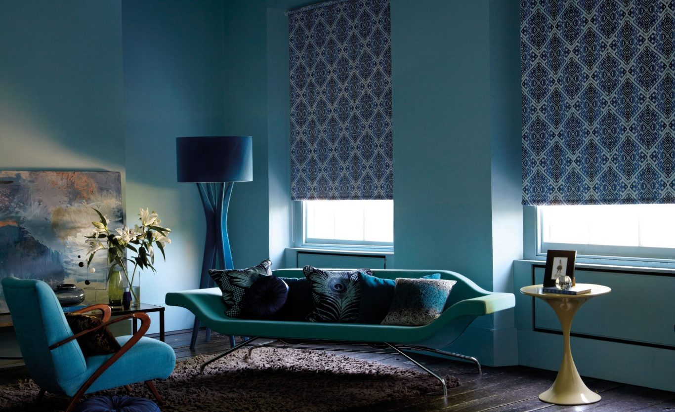 Blue patterned blackout roller blinds in living room