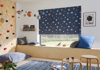 Space themed blackout roller blinds in a child's bedroom