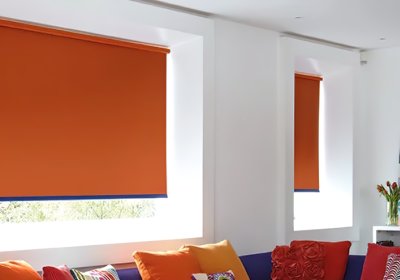 Orange roller blackout blinds in living room