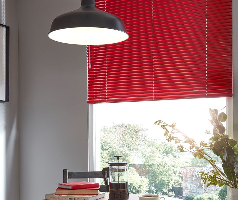 Red venetian blinds in dining room