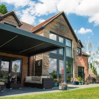 Outdoor pod with side panels over patio seating area