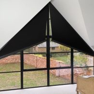 Motorised apex blinds in a triangular window